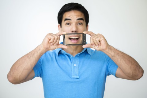 Mixed race man taking digital picture