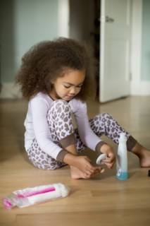 Mixed race girl using polish remover