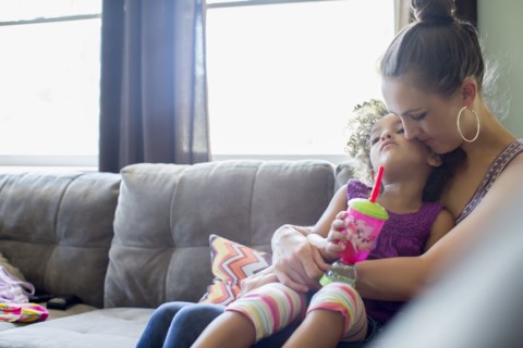 Mother holding daughter on lap