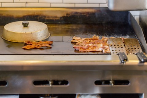 Bacon on griddle in restaurant