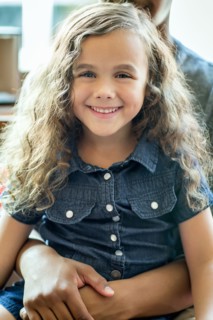 Mixed race girl sitting in lap