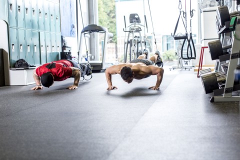 Pacific Islander man working out in gym