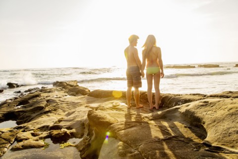 Couple holding hands on beach