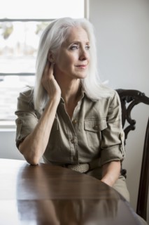 Older Caucasian woman sitting at table