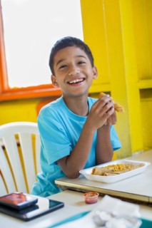 Hispanic boy eating in restaurant