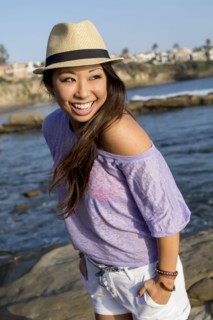 Mixed race woman smiling on beach