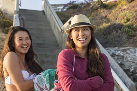 Women standing by steps on beach