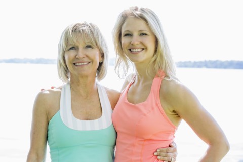 Caucasian mother and daughter smiling outdoors