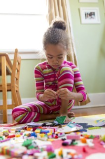 Mixed race girl playing in kitchen