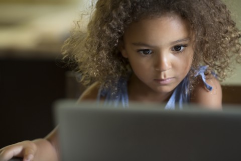Mixed race girls using laptop