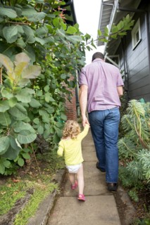 Father and daughter walking in backyard