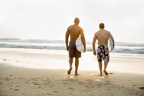 Men carrying surfboards on beach