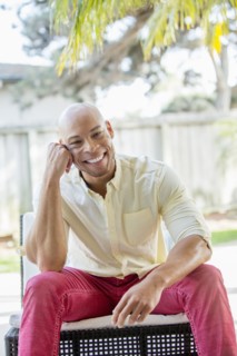 Mixed race man smiling in backyard