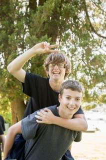 Caucasian teenage piggybacking in park