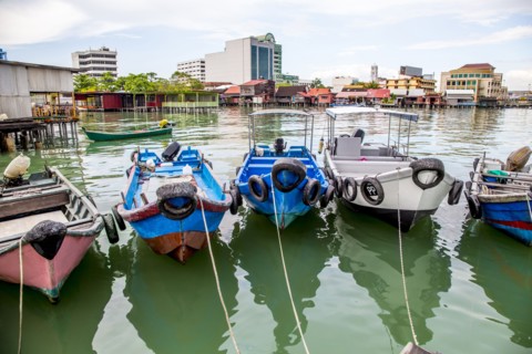 Fishing boats docked in urban harbor