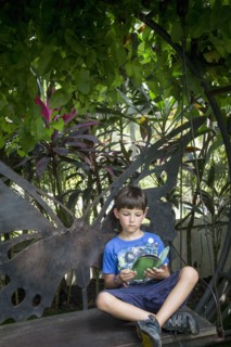 Caucasian boy reading on bench