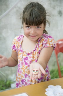 Caucasian girl holding painted rock