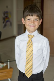 Caucasian boy smiling in formal wear
