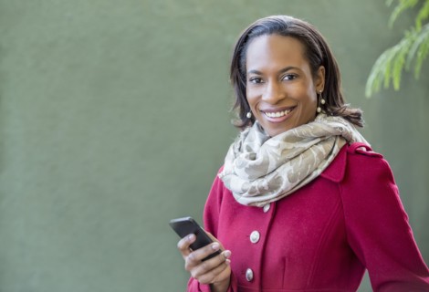 Black woman using cell phone outdoors