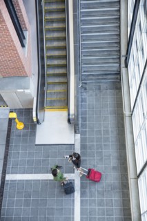 Businesswomen talking near stairs and escalator
