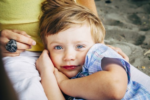 Boy laying in mother's lap