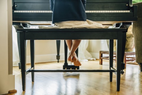 Mixed race girl playing piano