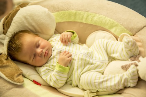 Close up of Caucasian baby boy sleeping on cushion