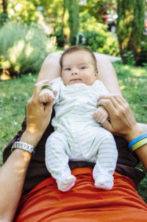 Caucasian father playing with baby boy in backyard