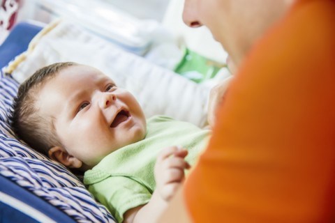 Caucasian father playing with baby boy