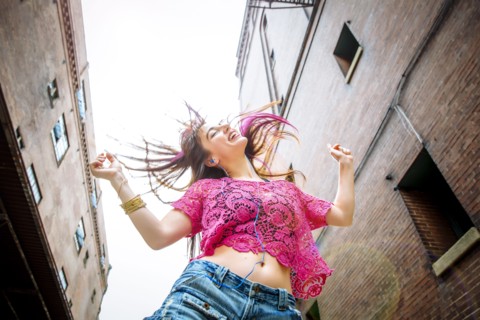 Low angle view of Caucasian woman dancing outdoors