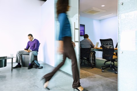Blurred view of businesswoman walking in office