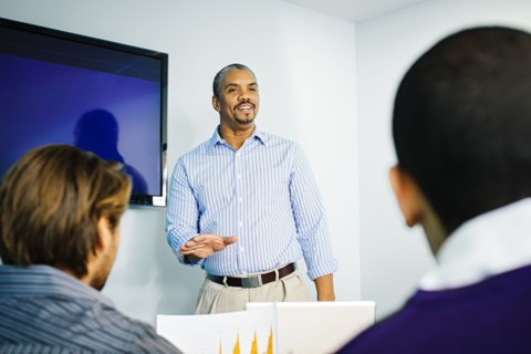 Businessman giving presentation in office meeting
