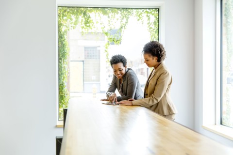 Businesswomen using digital tablet in office