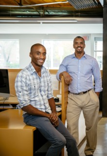 Black businessmen smiling in office