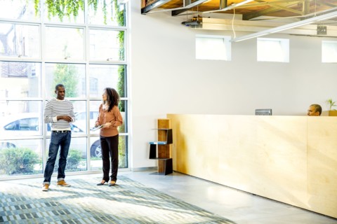 Business people talking in office lobby