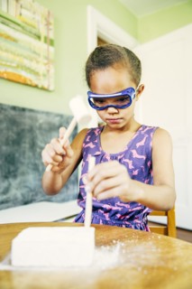 Mixed race girl doing science experiment at home