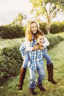 Caucasian children playing in crop field on farm