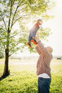 Caucasian father and son playing on farm