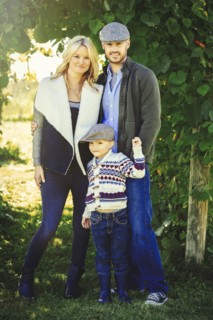 Caucasian family smiling under ivy leaves