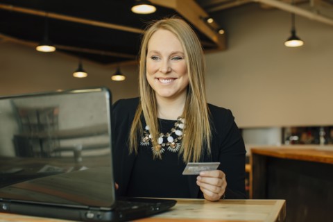 Caucasian businesswoman shopping online in cafe