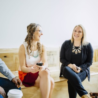Businesswomen talking in office lobby