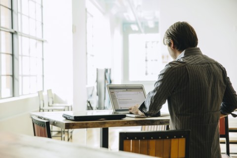 Caucasian businessman using laptop in office