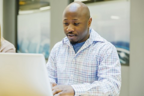 Businessman working on laptop in office
