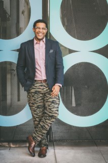 Stylish Mixed race businessman smiling outdoors