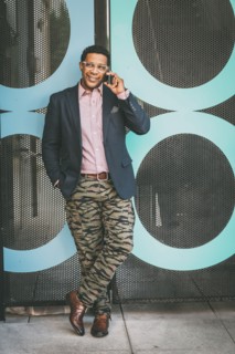 Stylish Mixed race businessman talking on cell phone outdoors