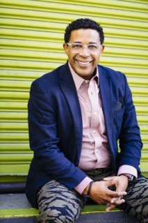 Mixed race businessman sitting at loading dock door