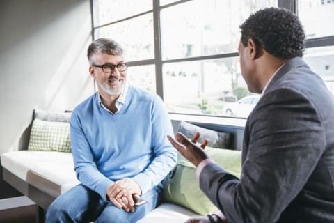 Businessmen talking in office lobby