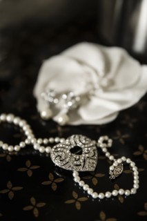 Close up of pearl and heart necklace on table