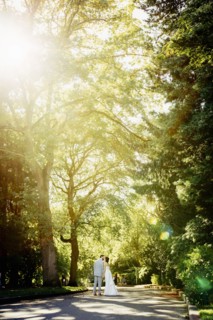 Caucasian bride and groom kissing on rural road
