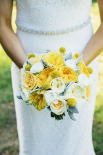 Caucasian bride holding bouquet outdoors